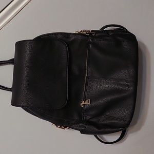 Black mini backpack with lots of pockets.